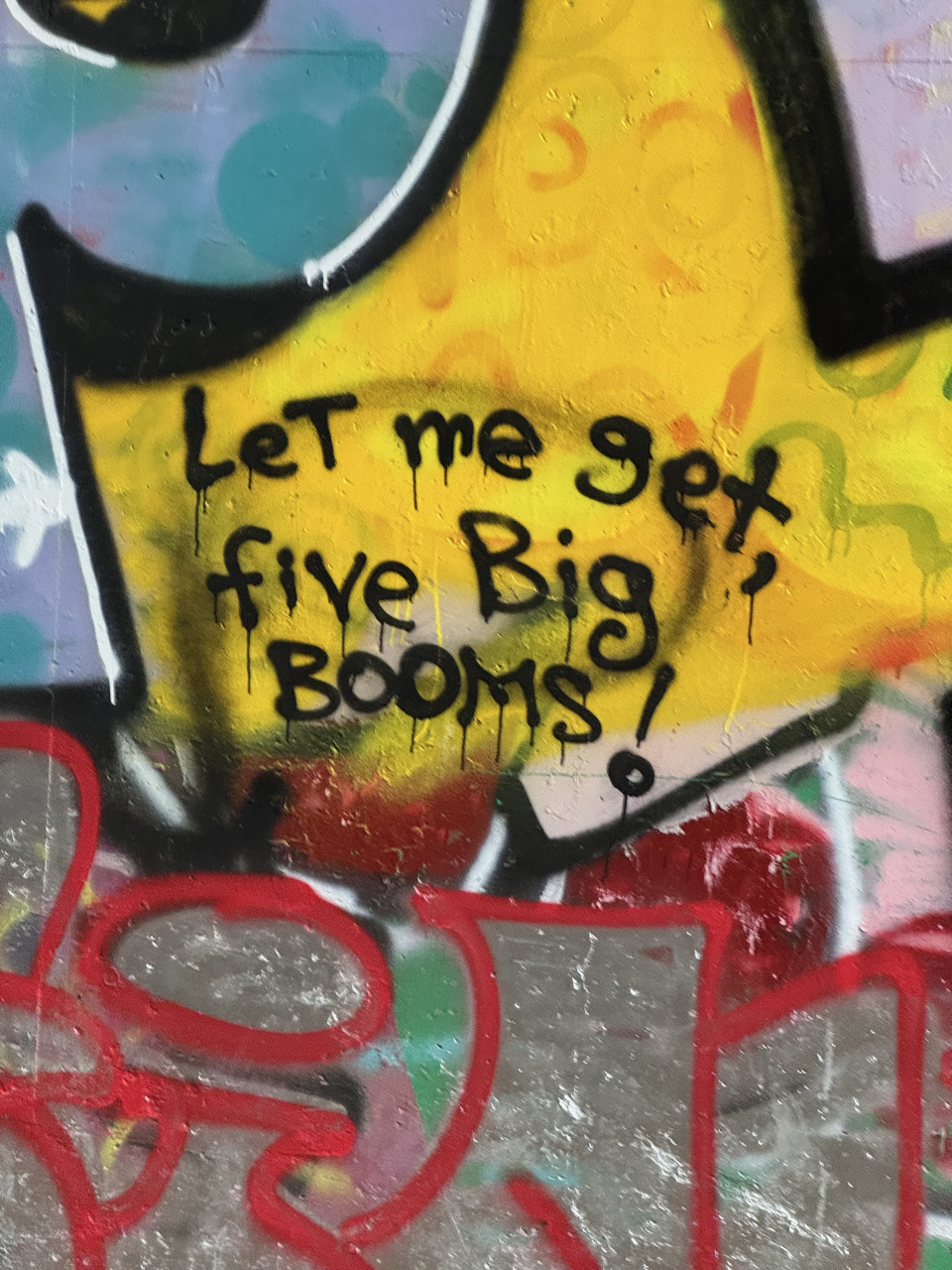 Graffiti saying "let me get, five big booms!"